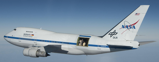 With the large door over its 2.5-meter German-built telescope wide open, NASA's Stratospheric Observatory for Infrared Astronomy 747SP aircraft soars over Southern California's high desert during a test flight in 2010 in preparation for its Early Science missions.