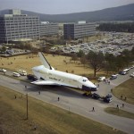 With Marshall’s administrative headquarters in the background, the Space Shuttle Enterprise heads south on Rideout Road.