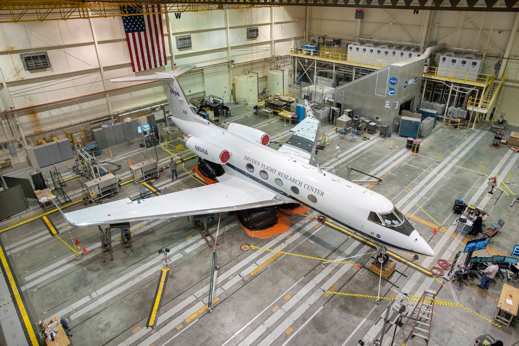 NASA's G-III flying test bed aircraft rests on three pneumatic lifting devices in preparation for loads testing in NASA Armstrong Flight Loads Laboratory