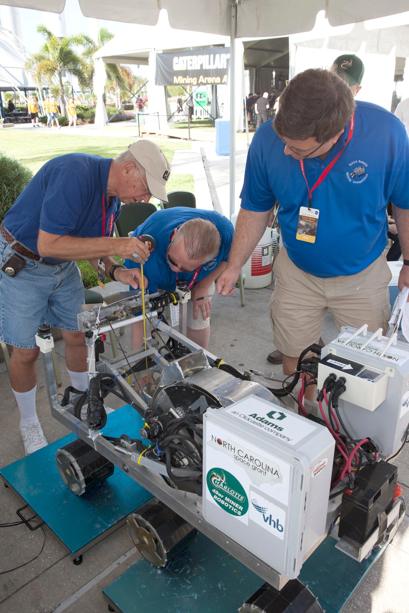 A team weighs in their robot miner during the NASA Robotic Mining Competition.