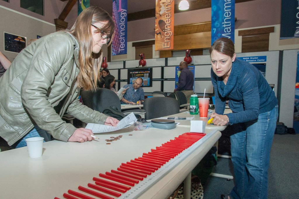 Educators prepare for a test run of the mass cart.