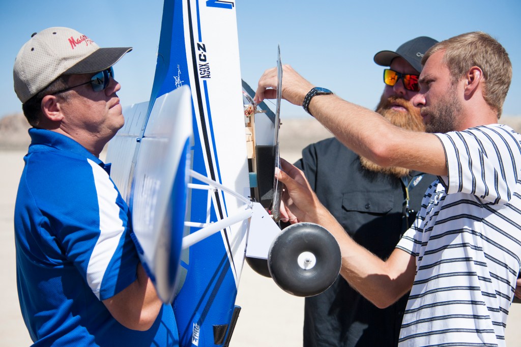 Derek Abramson, from left, Justin Hall, and Alexander Frock position the Prandtl-M glider