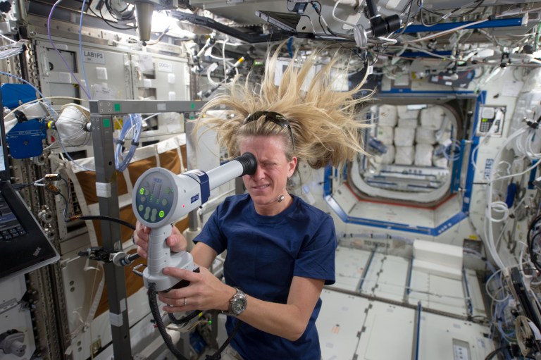 image of an astronaut conducting an eye exam while in the space station