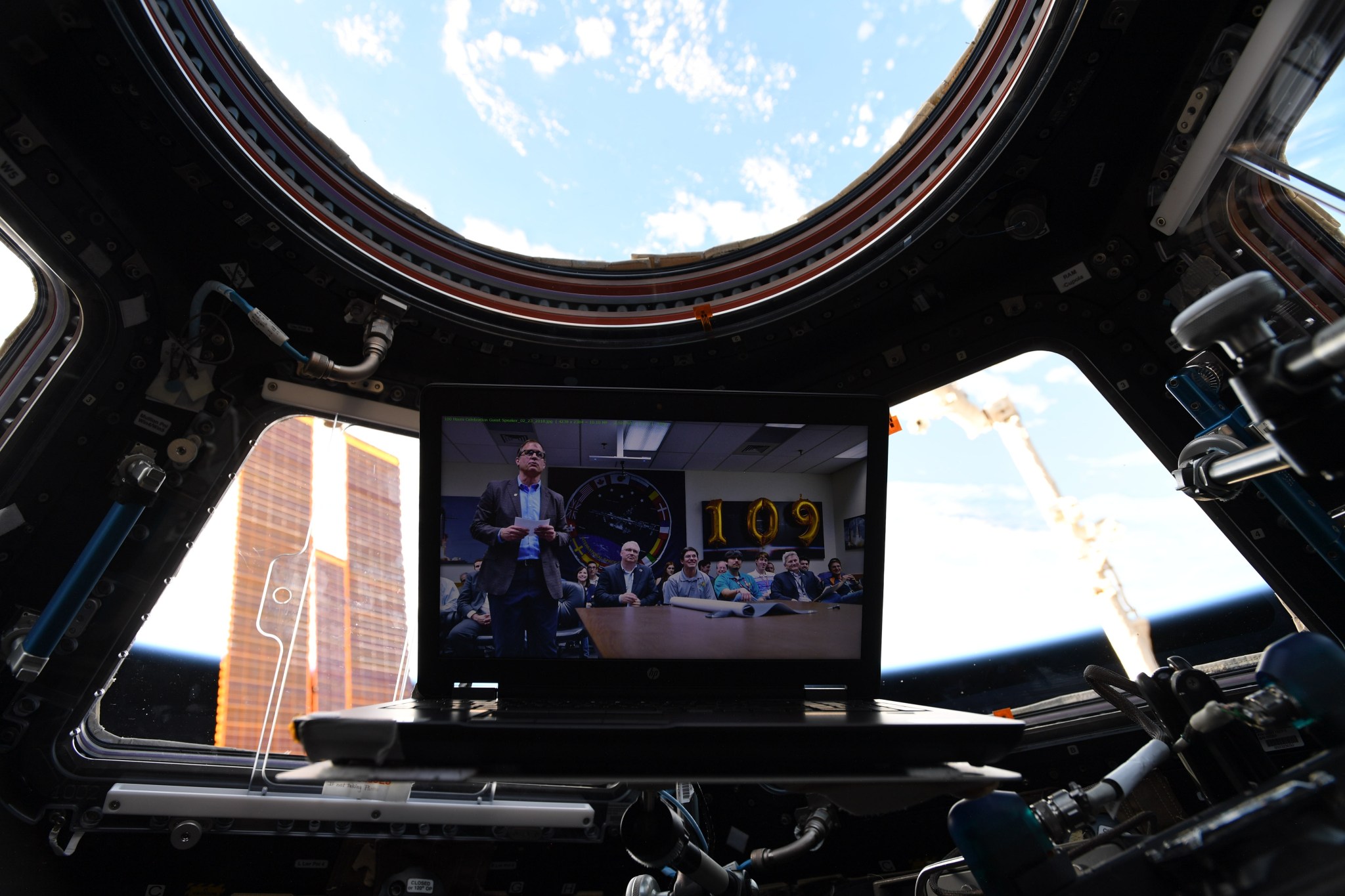 During a video call Feb. 23 with crew members aboard the ISS, Jonathan Pettus appears on a screen mounted in the cuppola.