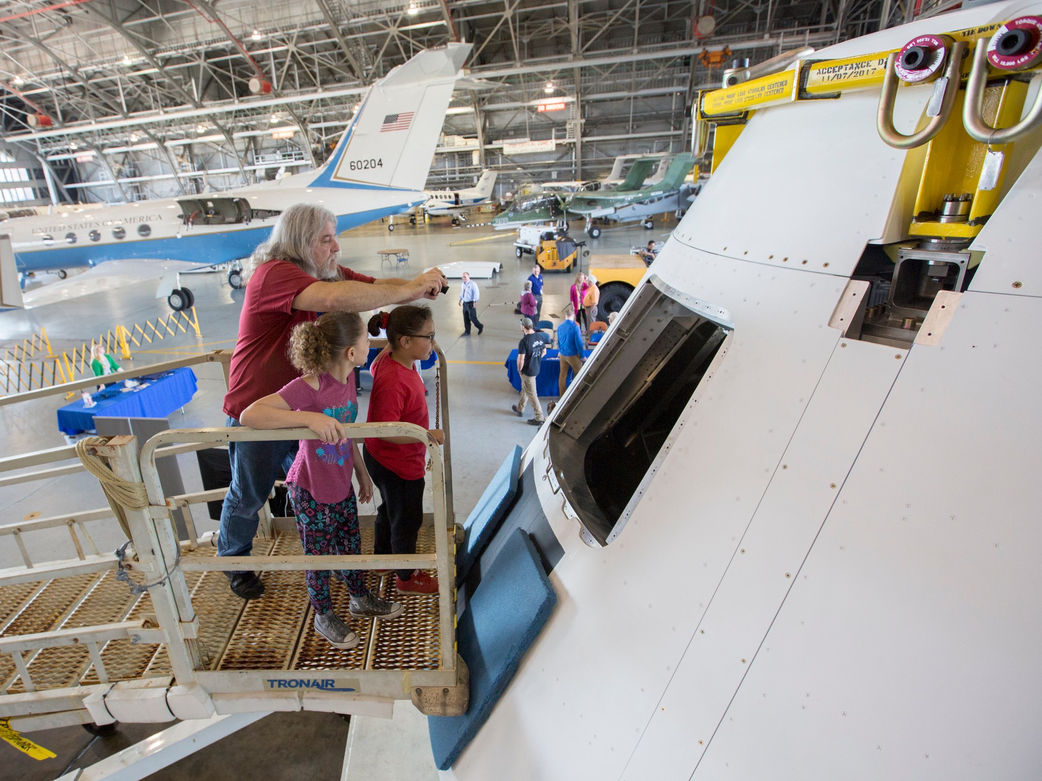 Savior Giuliana, left, is with his granddaughters, Belle Esquilin, 10, and Ame’ Esquilin, 8, viewing the Orion capsule.