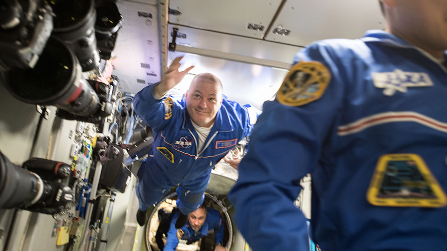 Newly arrived Flight Engineers Scott Tingle and Anton Shkaplerov float into the Zvezda Service Module.