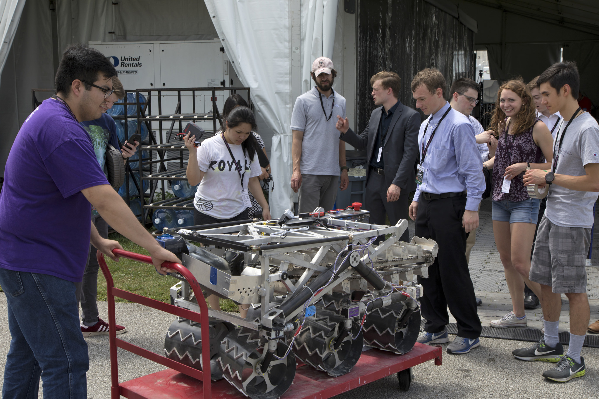 Team members from the University of Portland prepare their robot miner for its turn in the mining arena.