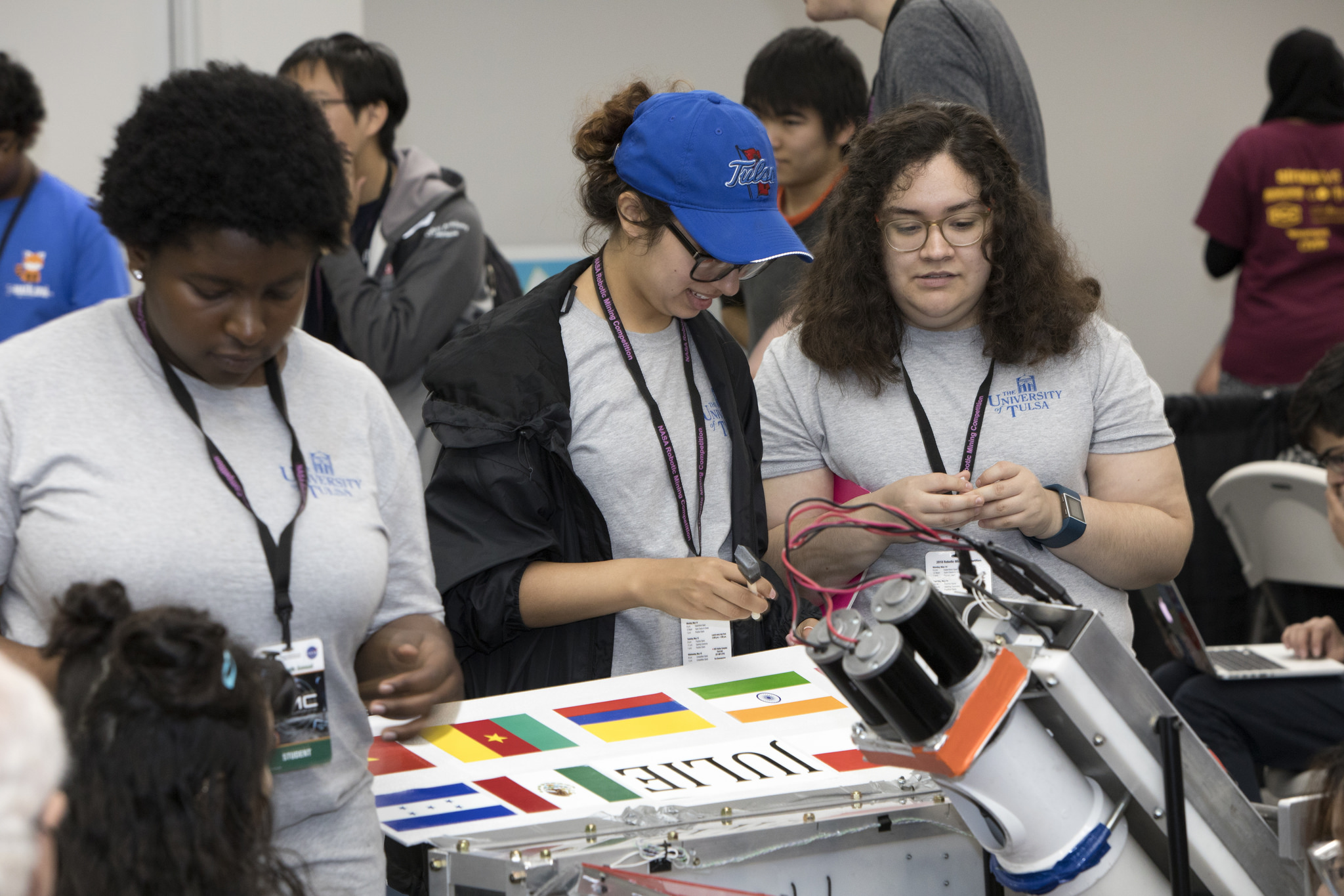 Team members from the University of Tulsa work on their robot miner.