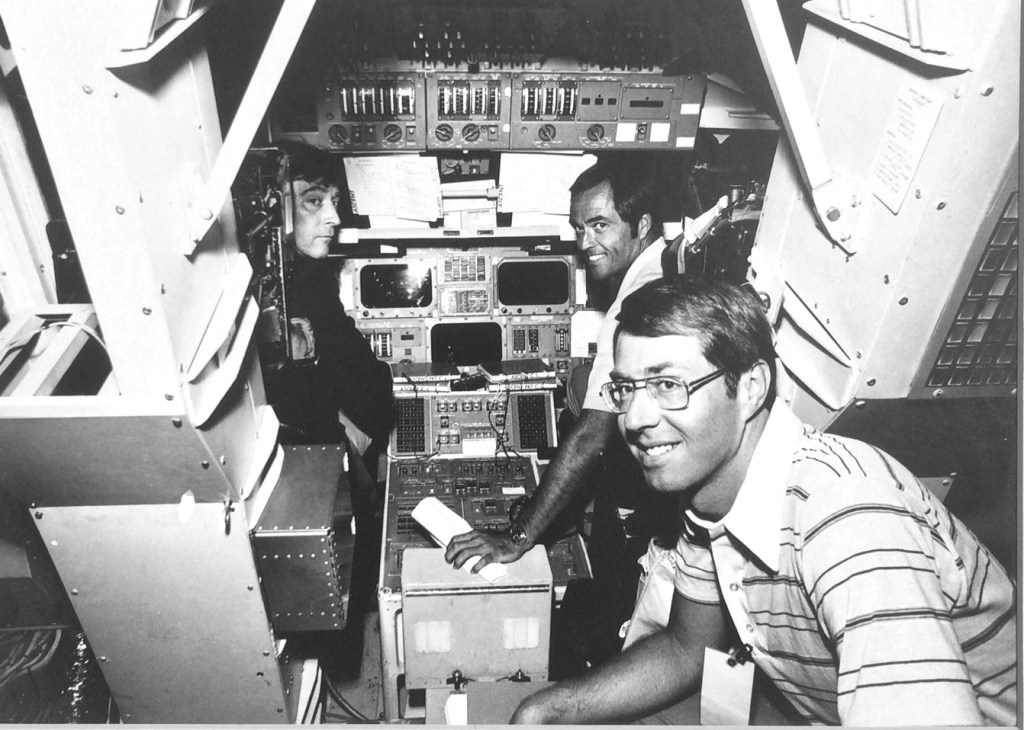 Journalist Craig Covault, foreground, with NASA astronauts John Young, left, and Bob Crippen, right.