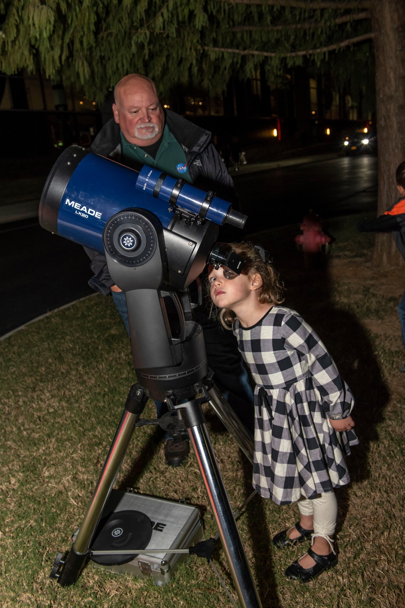 Brian Mitchell, left, gives Edie Hardiman an up close look at Earth's nearest neighbor.