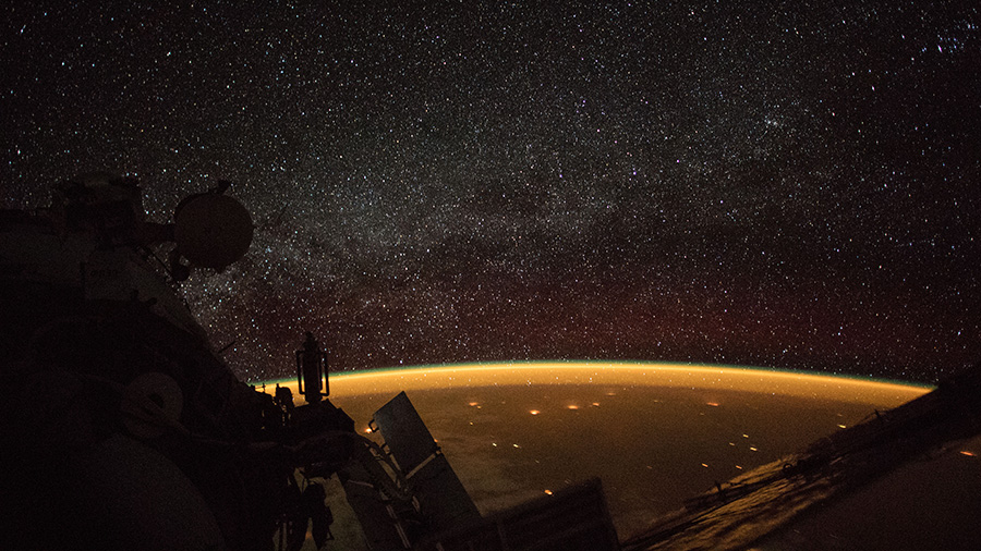 Celestial view of Earth's atmospheric glow and the Milky Way