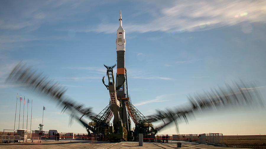 Launch pad gantry arms close around the Soyuz rocket