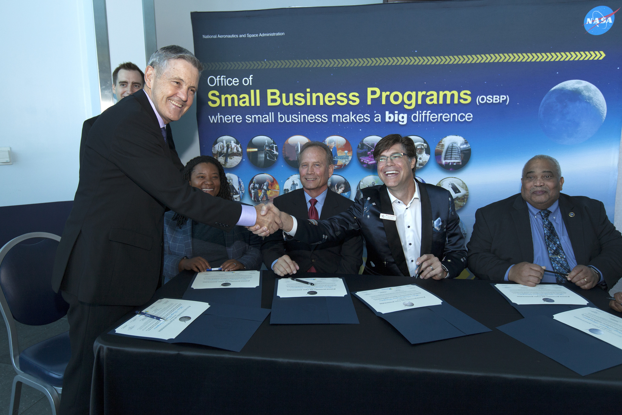 Kennedy Space Center Director Bob Cabana shakes hands during a Mentor-Protege Agreement signing