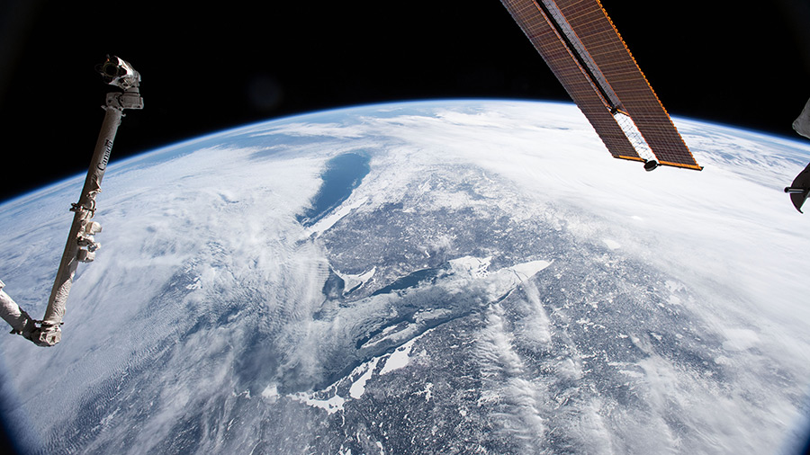 Lake Superior and Lake Michigan surrounded by the cloudy and frozen terrain