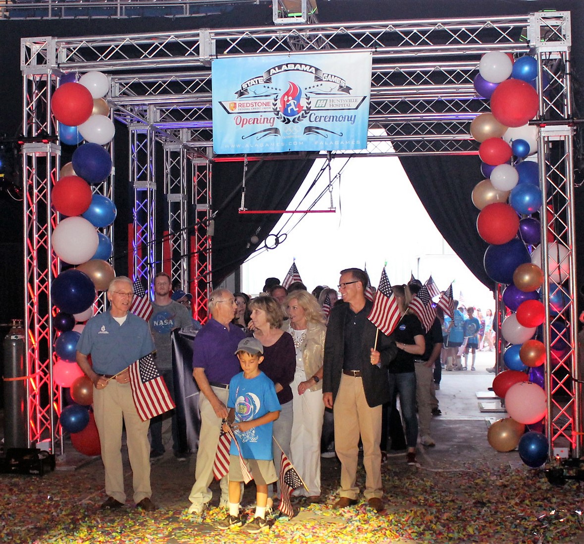 Steve Miley and his wife, Dana, join Marshall volunteers and interns to lead athletes into the Von Braun Center aren.