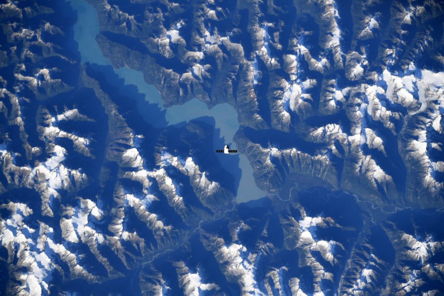 The SpaceX Dragon resupply ship is pictured above the Canadian Rocky Mountains