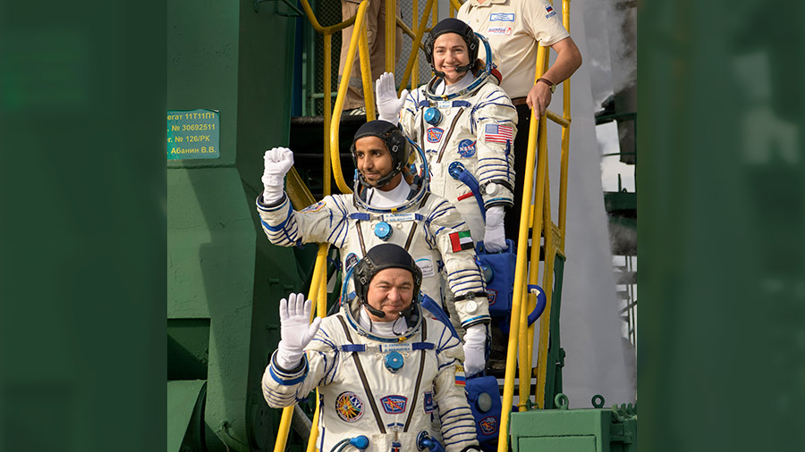 Soyuz MS-15 crewmates wave before boarding rocket