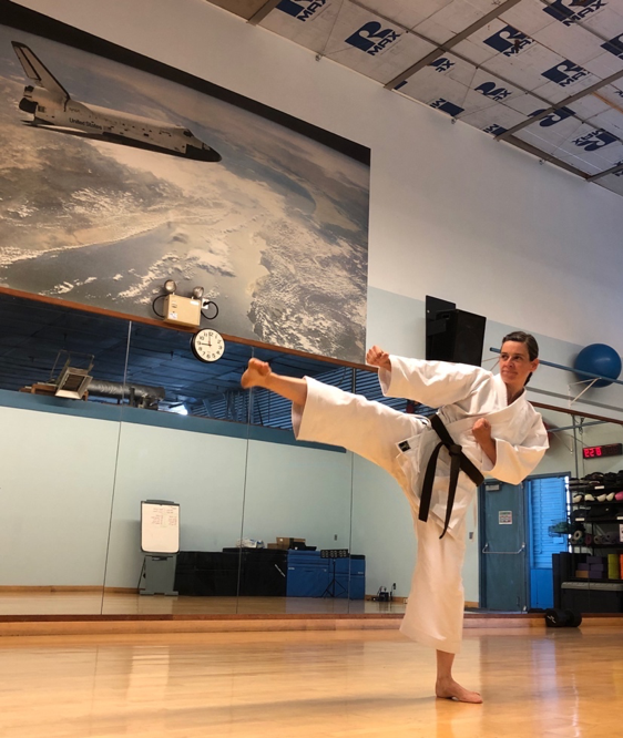 This is a recent picture of me at the NASA Ames fitness center practicing karate. There is a big picture of the space shuttle on