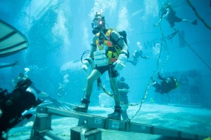 At the bottom of NASA's 40-foot deep Neutral Buoyancy Laboratory pool, a subject is pictured during a lunar one sixth G scuba run. Credit: NASA/Bill Brassard