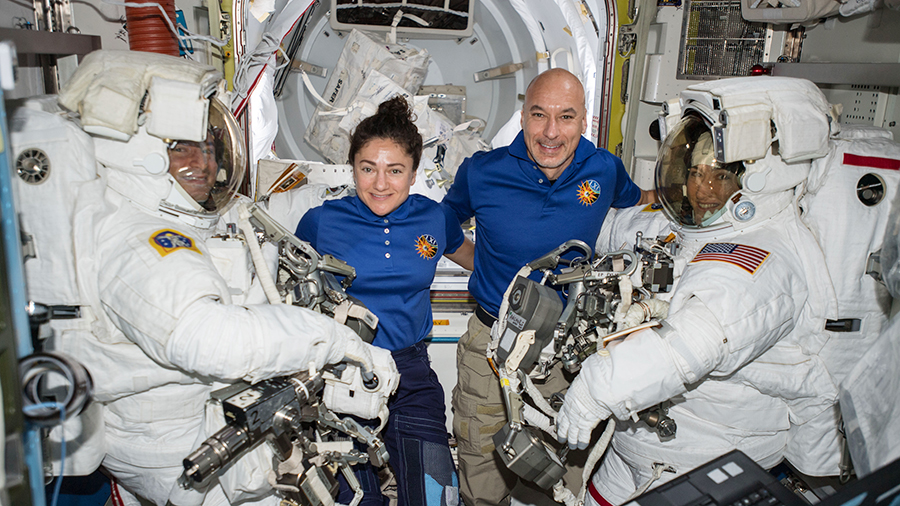 Astronauts assist spacewalkers in the Quest airlock