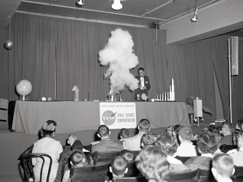NASA scientists demonstrated scientific concepts for an audience of adults and students.