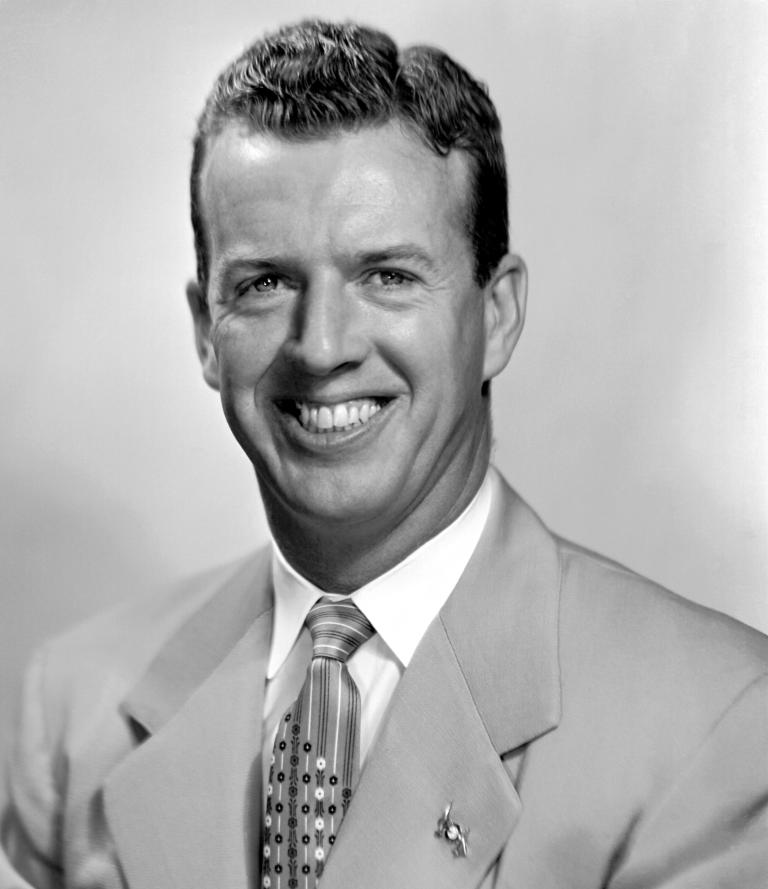 Black and white portrait of a man smiling.