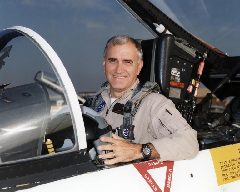 Man posed in cockpit.