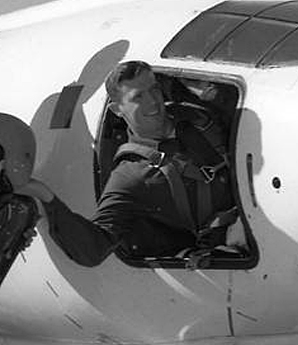 Man posing in cockpit.