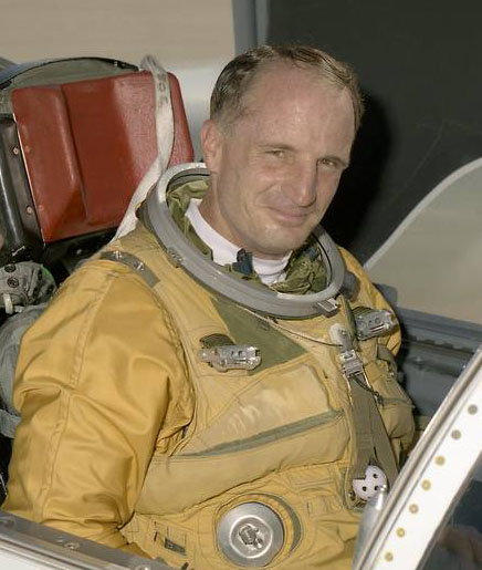 Man in aircraft smiling.