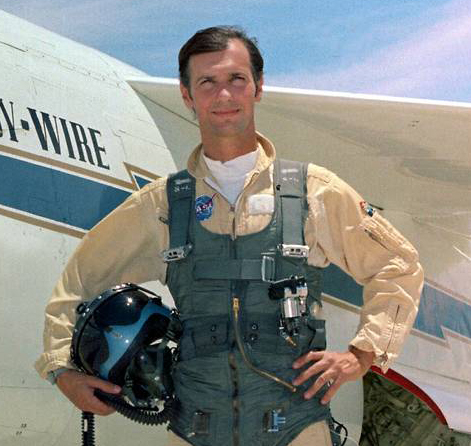 Man posed in front of aircraft.