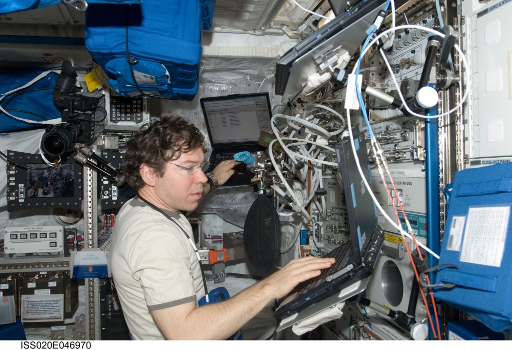 astronaut Michael Barratt using glasses in space