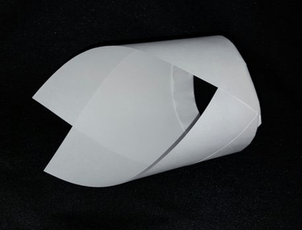 A paper glider shaped like a pointed cylinder