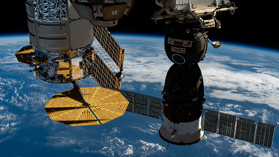 A U.S. Cygnus and a Russian Soyuz spacecraft are pictured docked to the station as it orbited above the Pacific Ocean.