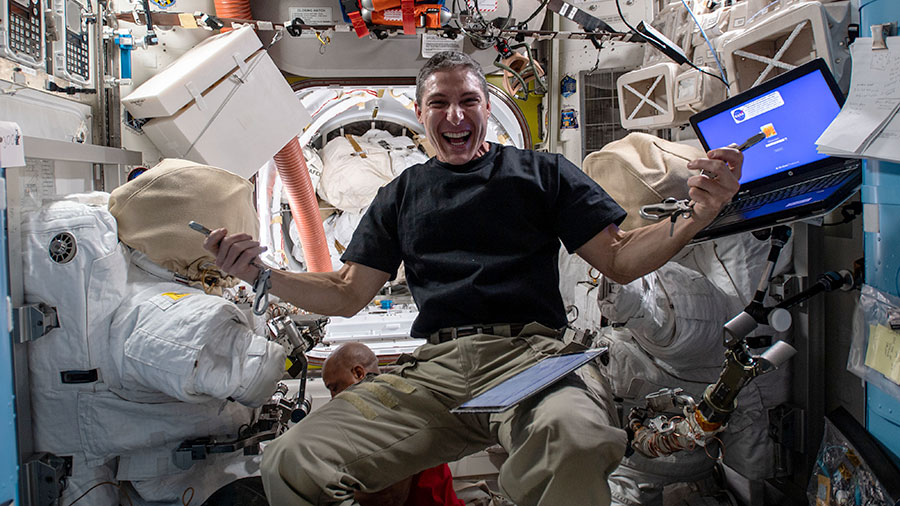 Flight Engineer Michael Hopkins works inside the Quest airlock configuring tools for planned spacewalks to continue maintenance on the outside of the International Space Station.