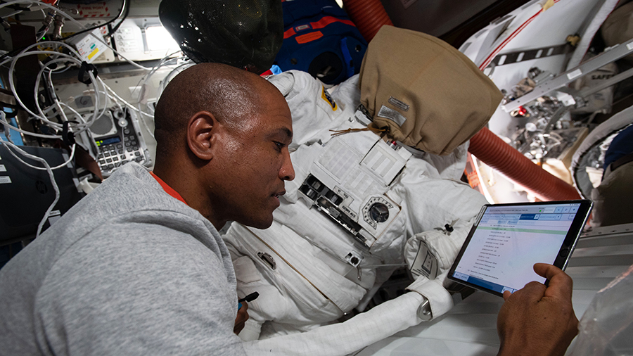 Expedition 64 Flight Engineer Victor Glover works on U.S. spacesuit maintenance inside the Quest airlock of the International Space Station.