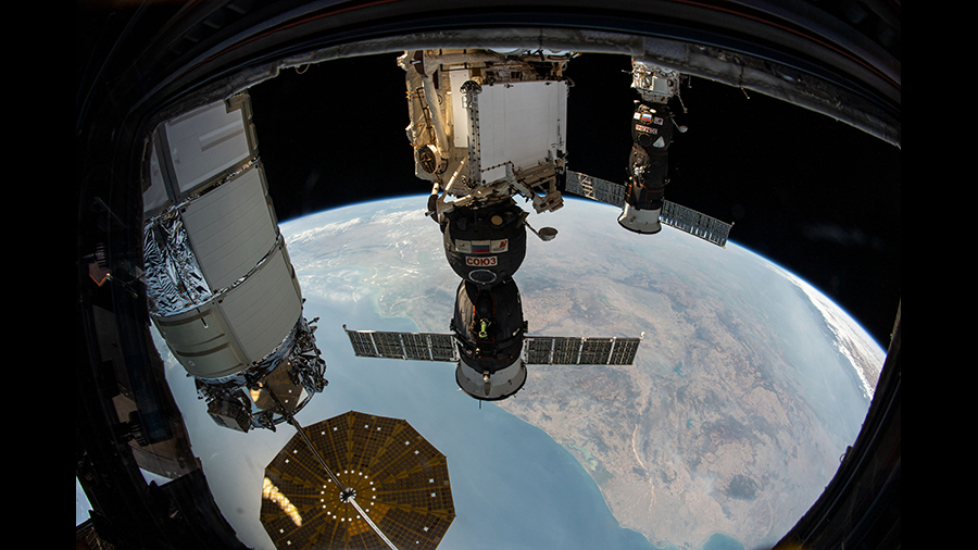 Three spaceships are pictured attached to the space station as the orbital complex flew 261 miles above the Bay of Bengal.