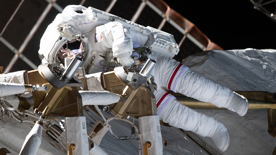 NASA astronaut Kate Rubins is pictured during a spacewalk to install solar array modification kits on the space station.