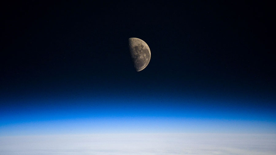 The Last Quarter Moon is pictured above the Earth's horizon as the station orbited over the Indian Ocean.