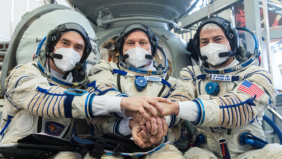 (From left) Expedition 65 crew members Pyotr Dubrov, Oleg Novitskiy and Mark Vande Hei, pose for a photo during Soyuz qualification exams in Moscow.