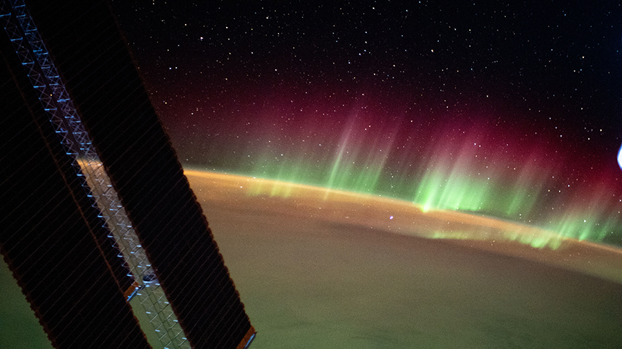 The aurora australis seemingly crowns the Earth's horizon as the station orbited above the southern Indian Ocean in between Asia and Antarctica.