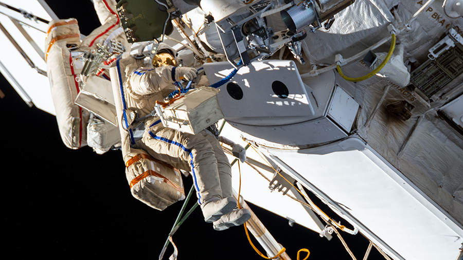 Russian spacewalkers (from left) Oleg Novitskiy and Pyotr Dubrov are pictured on Sept. 3 outfitting the Nauka multipurpose laboratory module with cables and handrails.