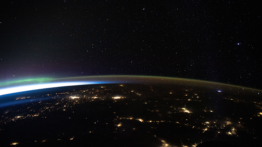 The city lights of northwest America, highlighted by an aurora, are pictured as the space station orbited above.