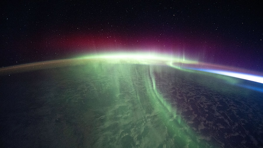 A vivid aurora streams over the Earth as the space station orbited above the southern Indian Ocean in between Australia and Antarctica.