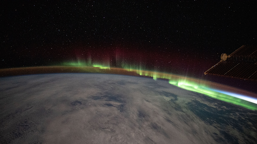 An aurora streams over the Earth as the space station orbited above the southern Indian Ocean in between Australia and Antarctica.