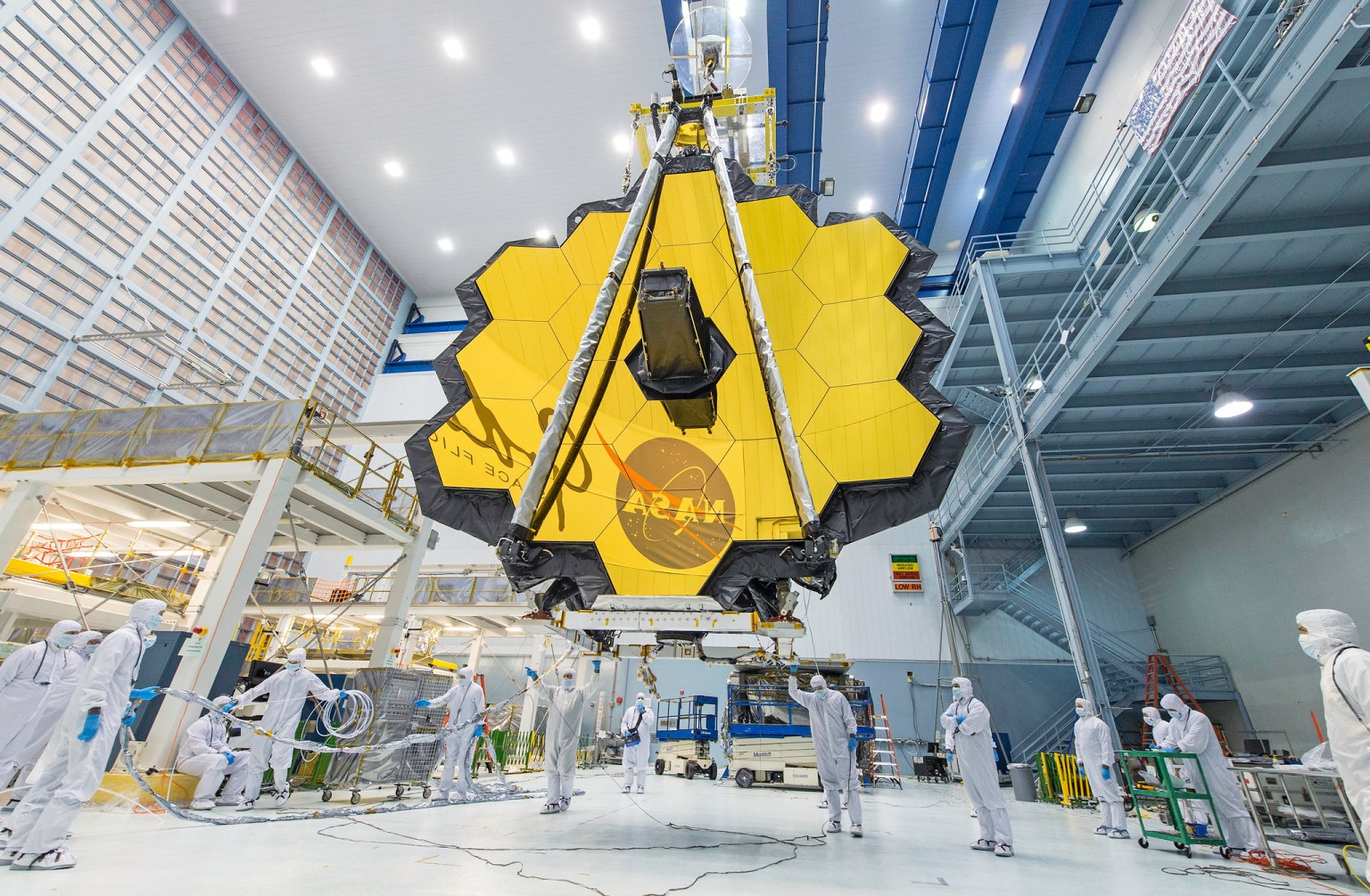 NASA technicians lift the James Webb Telescope