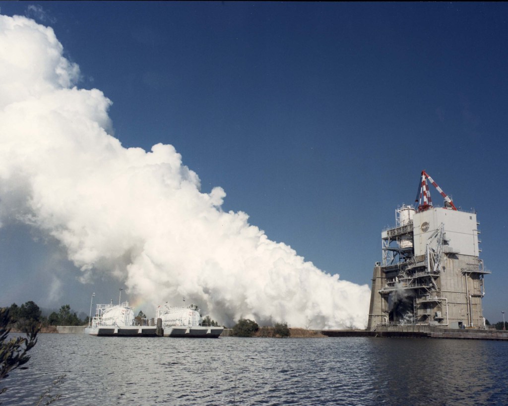 Clouds of steam billow out from the A-1 Test Stand during a test firing of a Space Shuttle Main Engine
