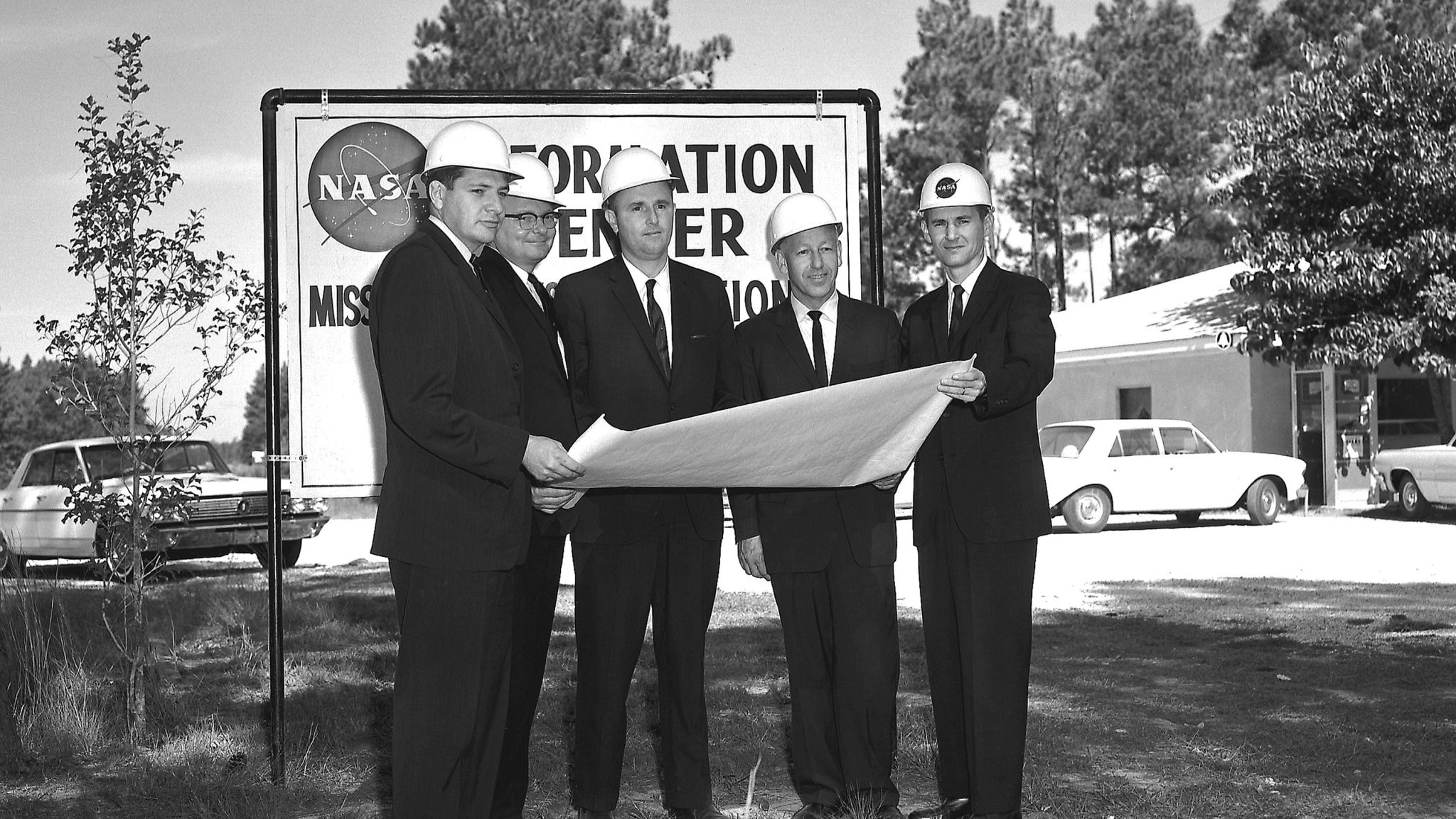 John Hillman (right) stands with NAA Officials at MTO (16 October 1963)