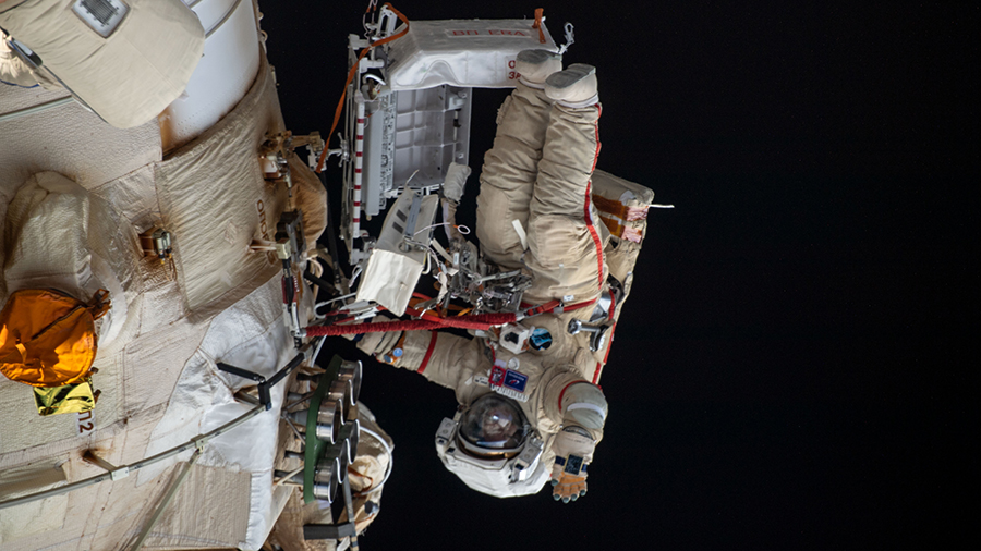 Roscosmos cosmonaut Oleg Artemyev waves to the camera during a spacewalk on April 18, 2022, to configure the European robotic arm.