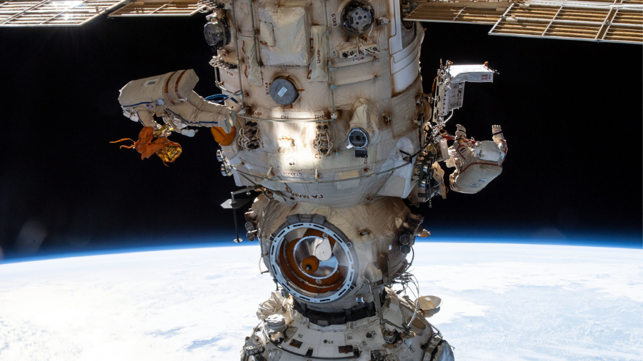 Cosmonauts (from left) Denis Matveev and Oleg Artemyev worked outside the station's Russian segment during the first spacewalk to outfit Nauka and configure the European robotic arm on April 18, 2022.