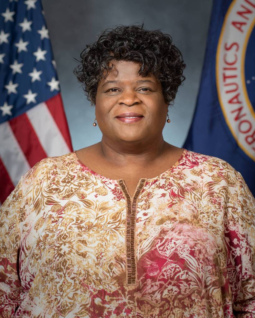 Portrait of Cynthia Calhoun with U.S. and NASA flags in background